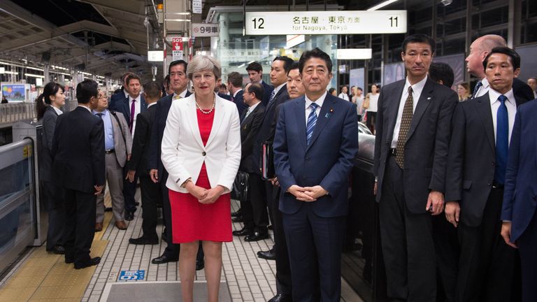 Theresa May and Shinzo Abe wait for a bullet train to Tokyo
