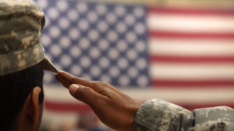 A soldier salutes the flag during a welcome home ceremony for troops arriving from Afghanistan on June 15, 2011 to Fort Carson, Colorado