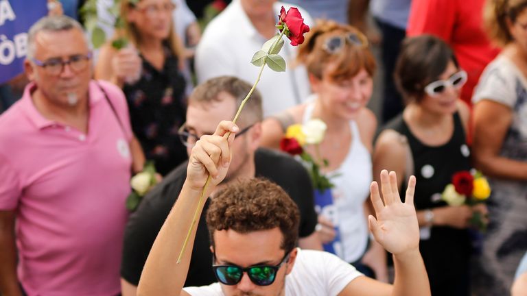 Roses were handed out to crowds during the march