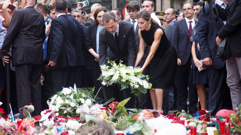 Spain&#39;s King Felipe and Queen Letizia place flowers at memorial site