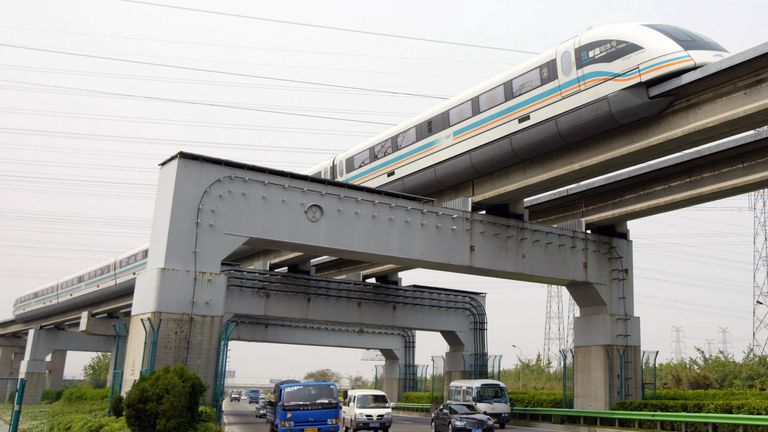 A maglev train passes above traffic in Shanghai, China