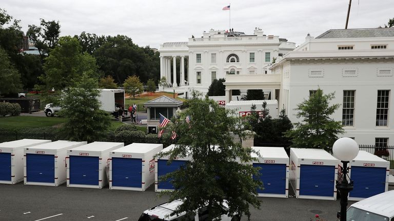 Furniture has been temporarily moved to containers outside