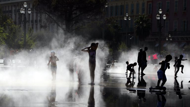 Children play in mist at a water fountain as a heatwave hits south of France in Nice, France August 2, 2017. REUTERS/Eric Gaillard