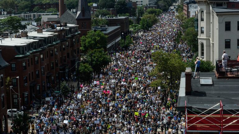A large crowd of people march towards the Boston Commons to protest the Boston Free Speech Rally in Boston,...