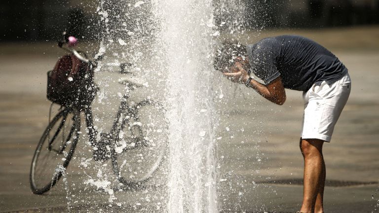 A man refreshes himself with the waters of a fountain at Piazza Castello in Turin on August 2, 2017, as they seek relief during a heatwave that continues to grip southern Europe. / AFP PHOTO / Marco BERTORELLO (Photo credit should read MARCO BERTORELLO/AFP/Getty Images)