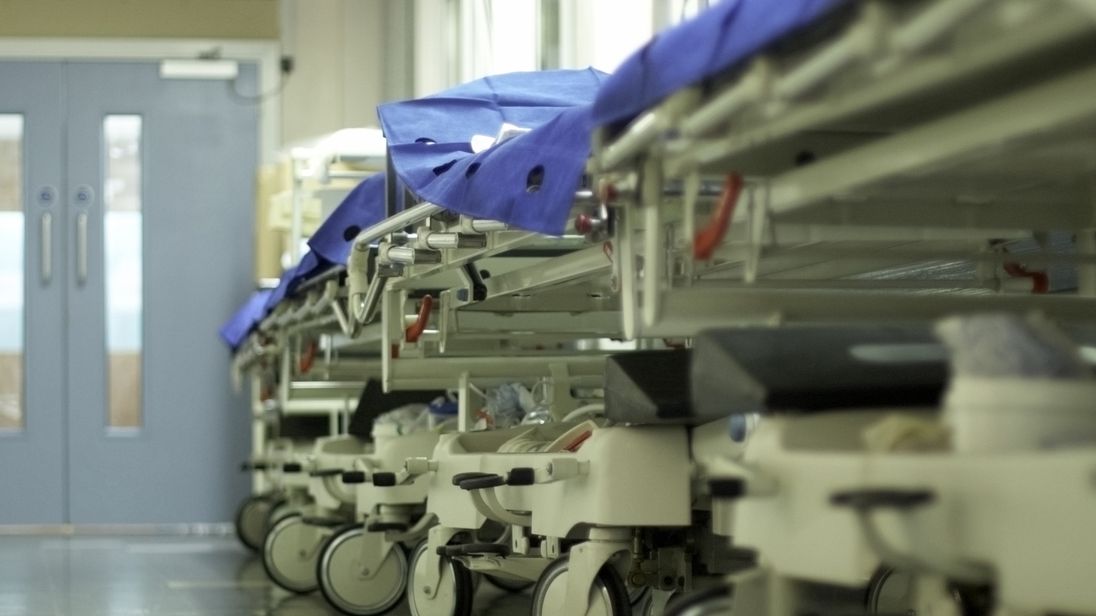 Hospital trolleys lined up in a corridor