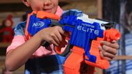 A child prepares to use a Nerf gun