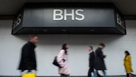Shoppers walk past the boarded up BHS store on Oxford Street