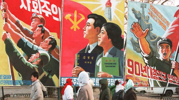 PYONGYANG, NORTH KOREA - FEBRUARY 7: Pedestrians walk past propaganda posters 27 January in central Pyongyang. The Central People&#39;s Committee announced 07 February that 16 February will be &#39;the greatest holiday of the nation&#39; to celebrate the 53rd birthday of North Korean leader Kim Il-Sung. (COLOR KEY: Flags are red.) AFP PHOTO (Photo credit should read Yoshikazu TSUN/AFP/Getty Images)