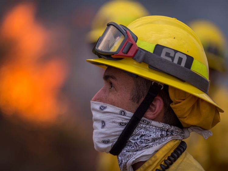 Firefighters use hoses and helicopters to fight the La Tuna Fire on September 2, 2017 near Burbank, California