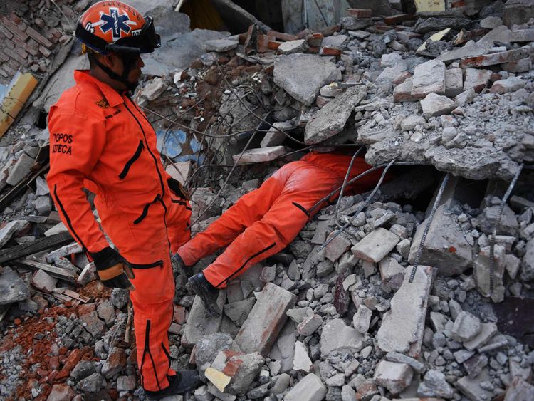 Member of the Moles specialised rescue team search for survivors in Juchitan de Zaragoza