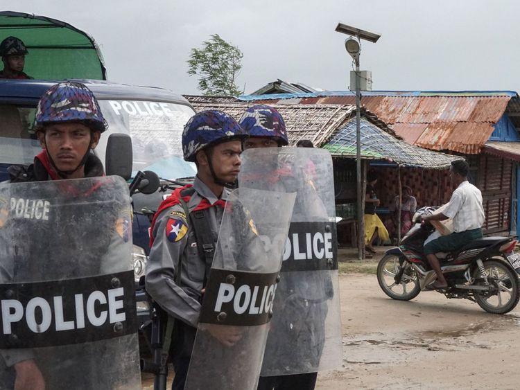 Myanmar police standing guard at an Internally Displaced Persons camp in Rakhine State