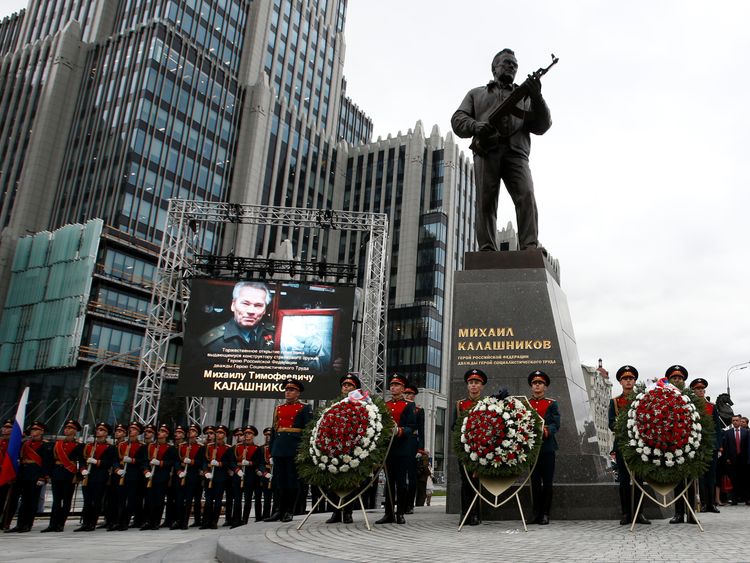 Guards of honour stand next to a monument to Mikhail Kalashnikov