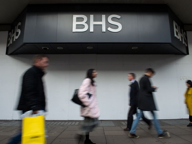 Shoppers walk past the boarded up BHS store on Oxford Street