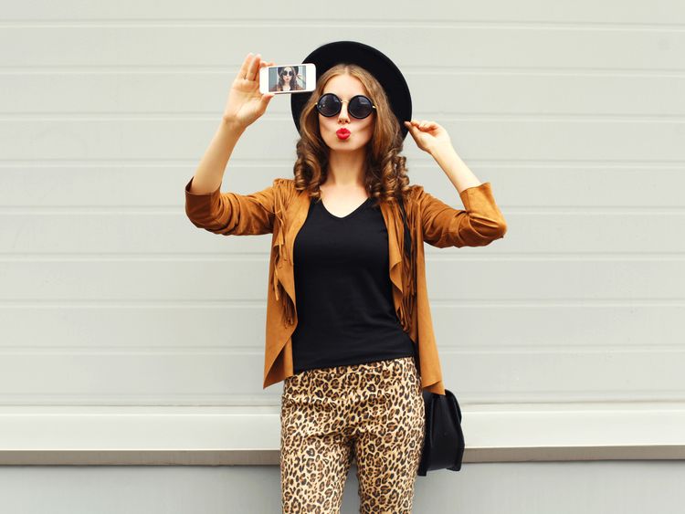 Woman poses for selfie on mobile phone camera
