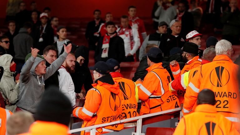 FC Koln fans square up to stewards inside the stadium before the delayed match