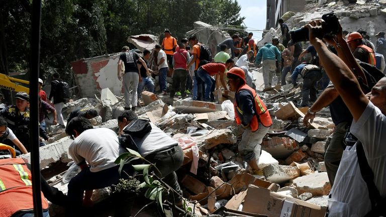 Rescuers frantically try to move rubble after the 7.1 magnitude quake
