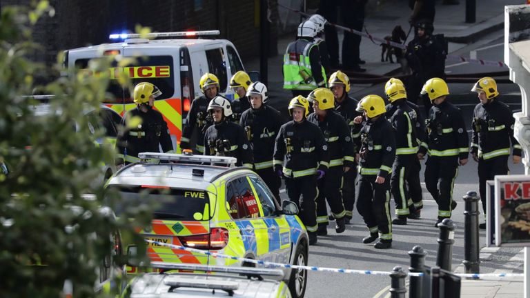 Members of the emergency services work near Parsons Green tube station