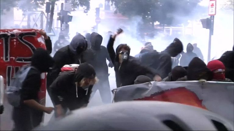French protesters throw rocks at police in clashes over labour laws