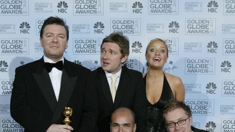 The cast of The Office pose with a Golden Globe after winning best TV comedy series in 2004