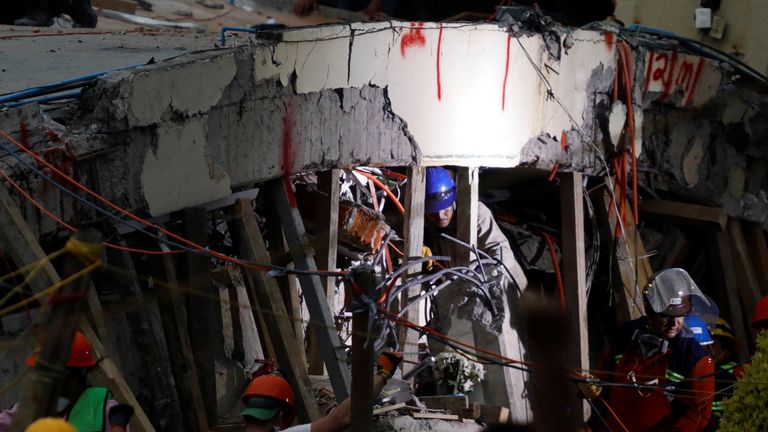 Rescue workers search through the rubble for students at Enrique Rebsamen school 