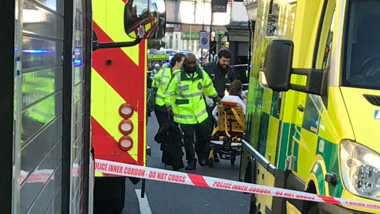 Emergency personnel attend to a person after an incident at Parsons Green underground station in London
