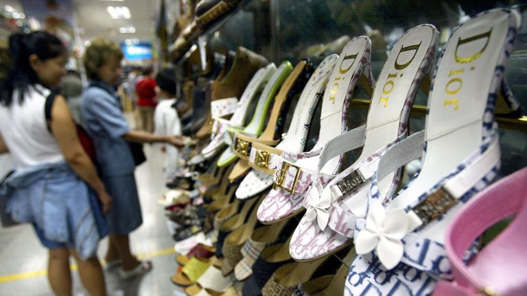 Counterfeit name brand shoes are on display at a Beijing clothing market