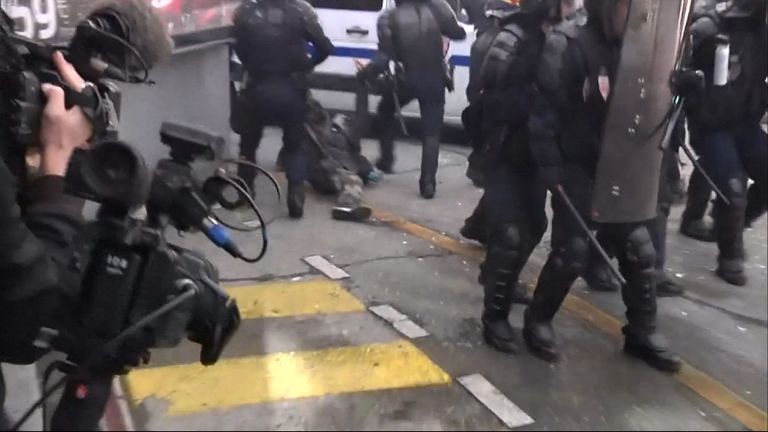A protester is dragged away by police during protests over labour laws