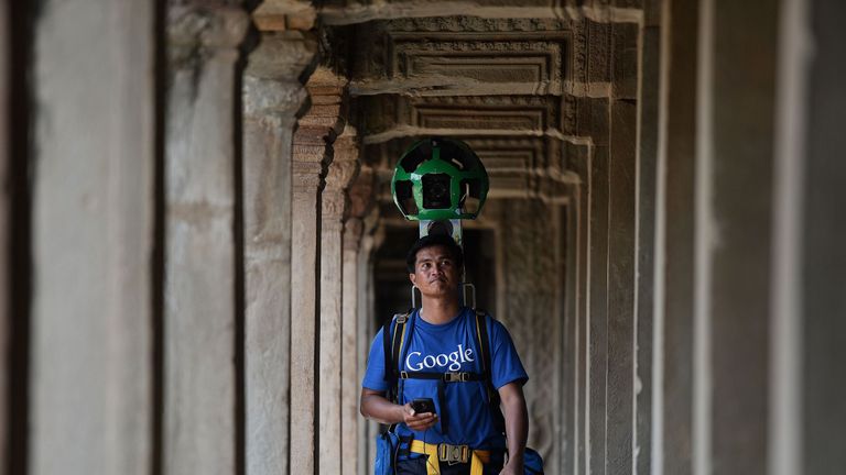 A Cambodian technician carries a back-pack mounted with a device housing 15 cameras as he demonstrates the technique used to digitally map the Angkor Wat temple, part of the Angkor architectural complex in north-western Cambodia on April 3, 2014