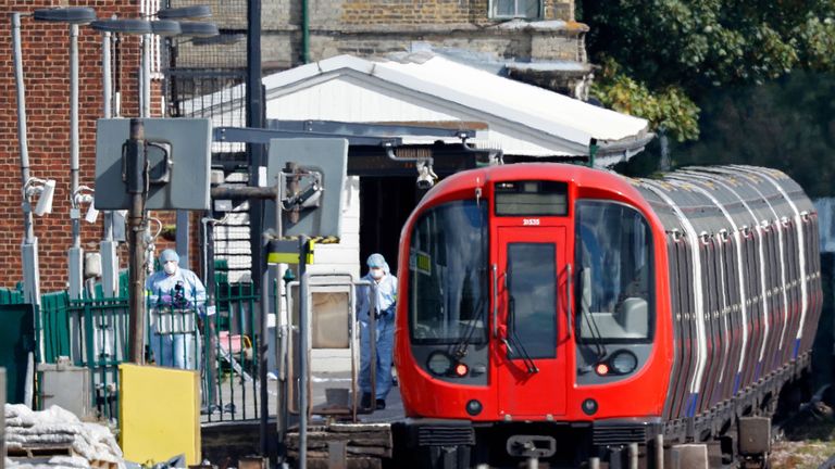 A forensic tent is seen next to the stopped tube train at Parsons Gree