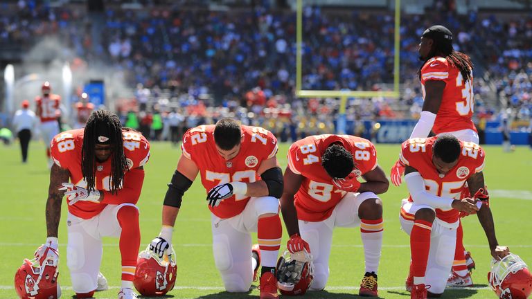 Terrance Smith #48, Eric Fisher #72, Demetrius Harris #84, and Cameron Erving #75 of the Kansas City Chiefs is seen taking a knee 