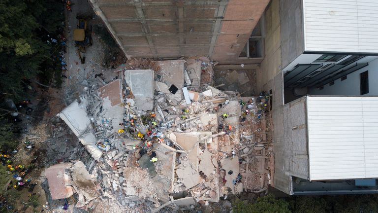 Search and rescue operations are carried out at the site of a collapsed building 