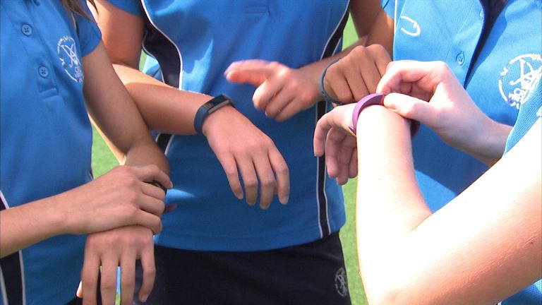 Children using exercise tracking devices at school