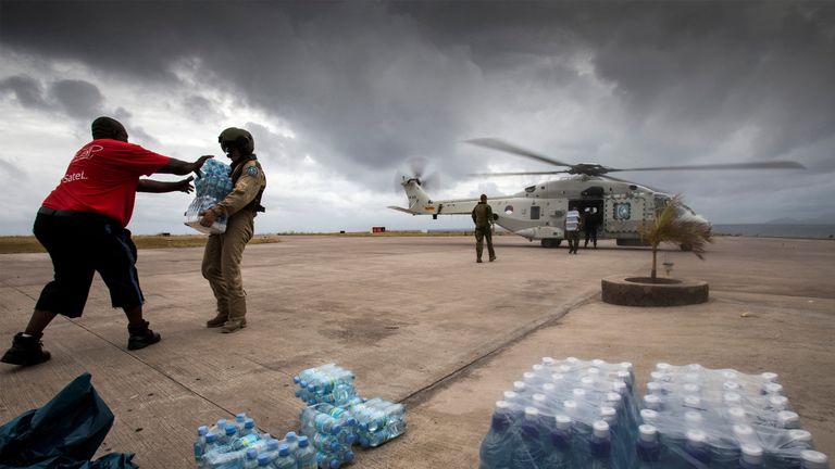 Dutch Army soldiers unload bottles of drinking water at the Sint Maarten International Airport on Saint Martin Island
