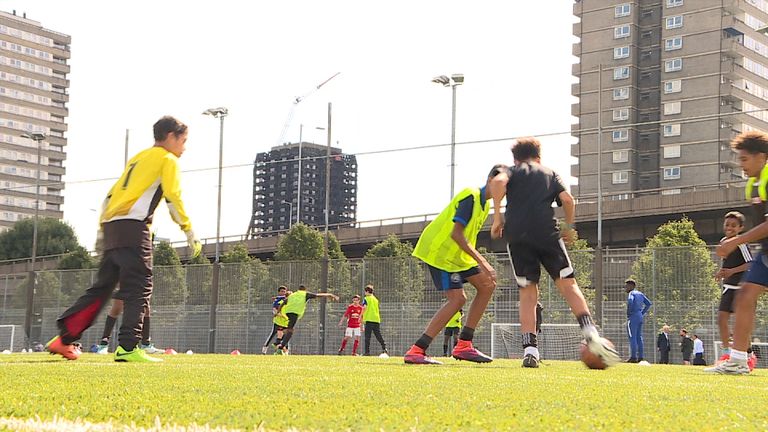 Children play football near the Grenfell Tower