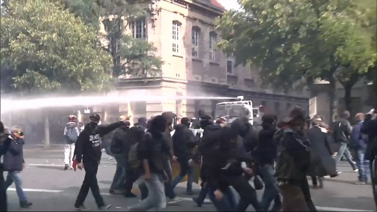 Police unleash a water cannon on protesters in Paris
