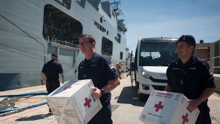 Members of the Royal Navy carry medical supplies on board the amphibious assault ship HMS Ocean at the Naval Base in Gibraltar on September 11, 2017, before leaving to provide humanitarian assistance and vital aid to British Overseas Territories and Commonwealth partners affected by Hurricane Irma. 