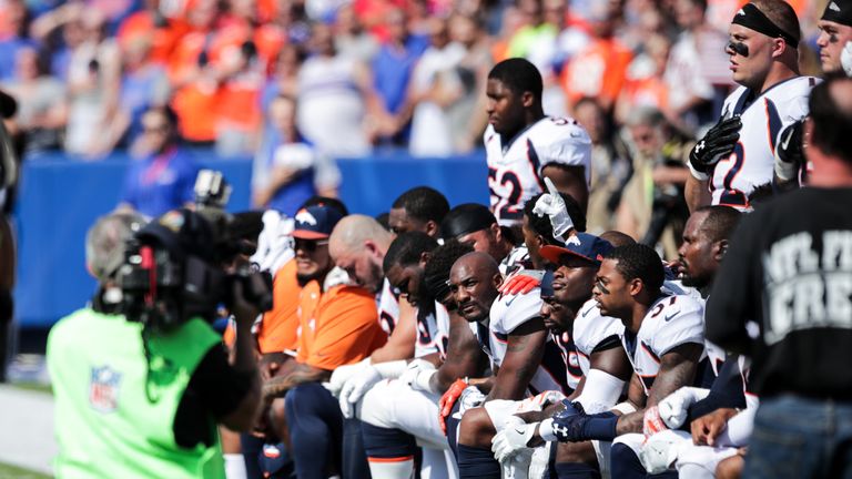 Denver Broncos players kneel during the American National Anthem before an NFL game against the Buffalo Bills 