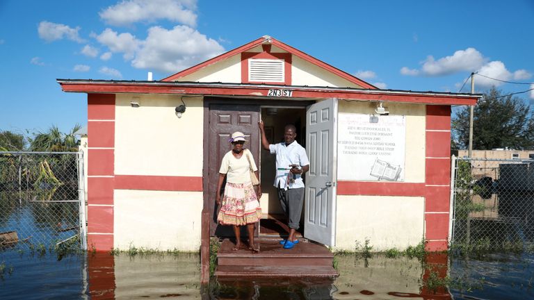Pastor Louicesse Dorsaint stands with his wife Maria in front of their church, Haitian United Evangelical Mission in Immokalee, Florida