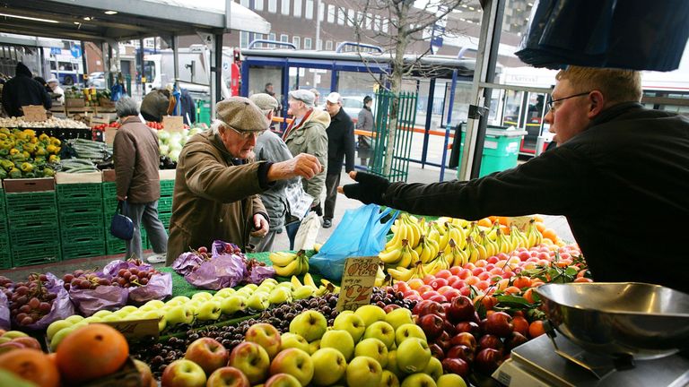 A stall holder sells his fruit and vegetables at the Bull Ring Market in Birmingham