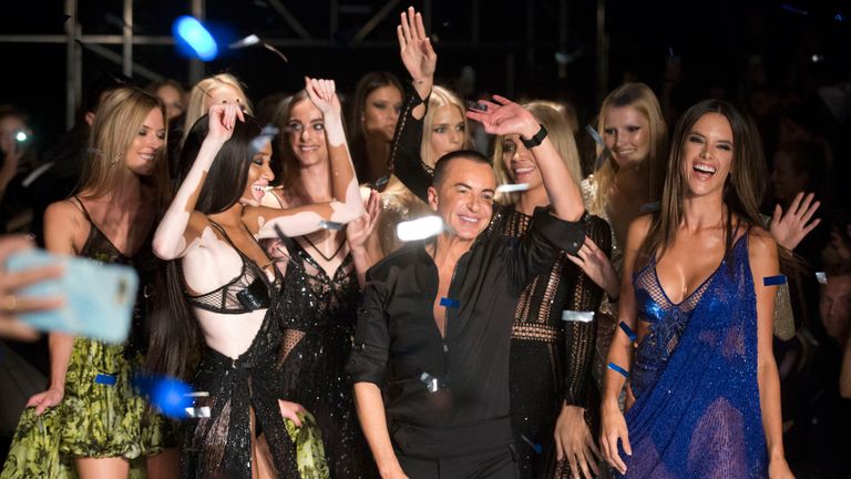 Designer Julien Macdonald greets the audience after his show