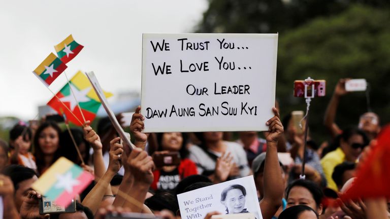 Supporters of Aung San Suu Kyi listen to her speech to the nation