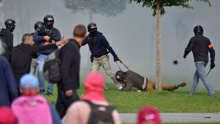 Policemen detain a protester in Nantes