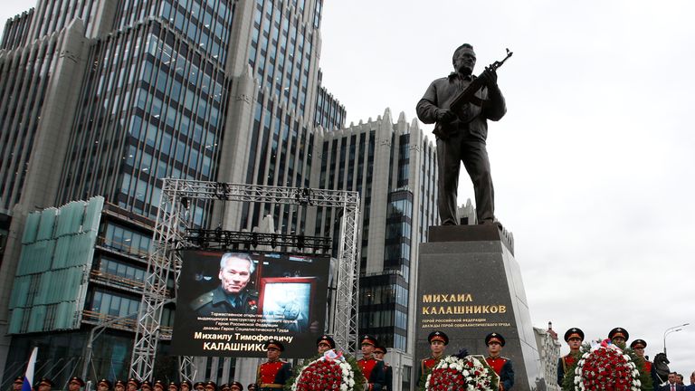 Guards of honour stand next to a monument to Mikhail Kalashnikov