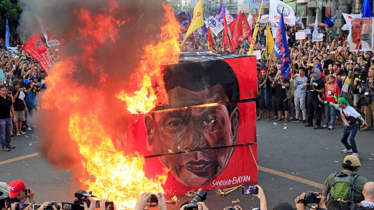 Protesters burn a cube effigy with a face of President Rodrigo Duterte during a National Day of Protest in metro Manila, Philippines 
