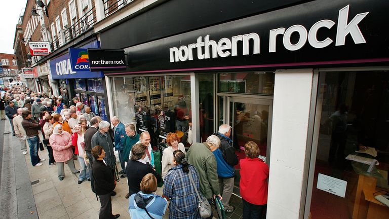 Customers wait in line to remove their savings from a branch of The Northern Rock bank on September 17, 2007 in Kingston-Upon-Thames, England