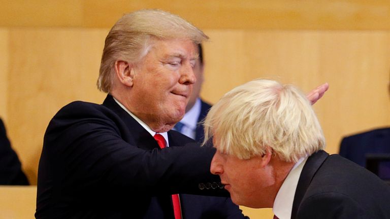 Donald Trump pats Boris Johnson on the back as they participate in a session on reforming the United Nations in New York