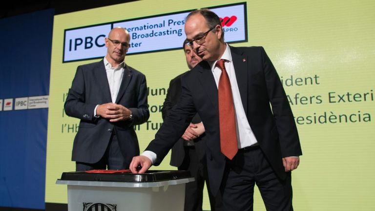 Catalan officials show off the ballot boxes to be used in the disputed referendum