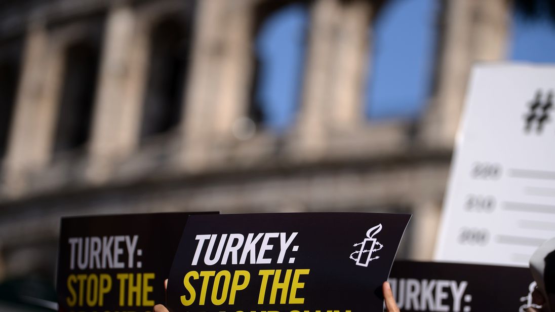 Amnesty International activists hold placards as they protest against the arrest of rights activists in Turkey on 20 July 2017