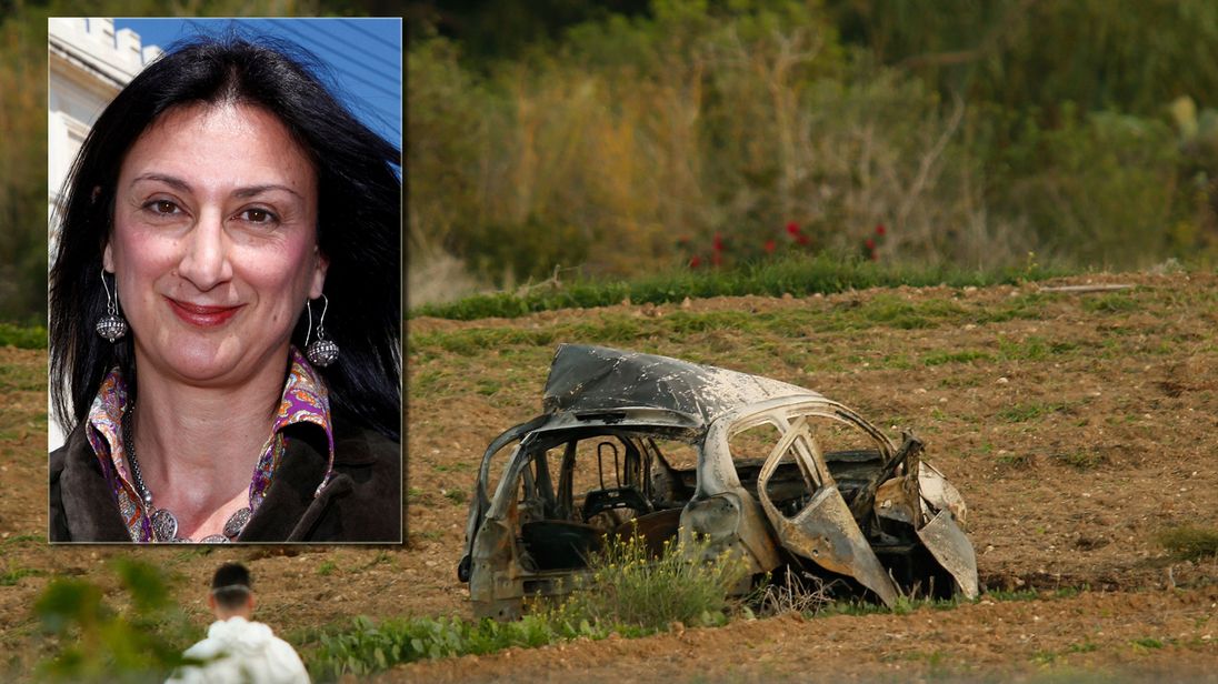 A forensics expert walks in a field after a powerful bomb blew up a car killing investigative journalist Daphne Caruana Galizia in Bidnija, Malta